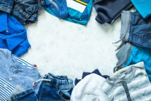 Child clothes - jeans, polo and sneakers top view